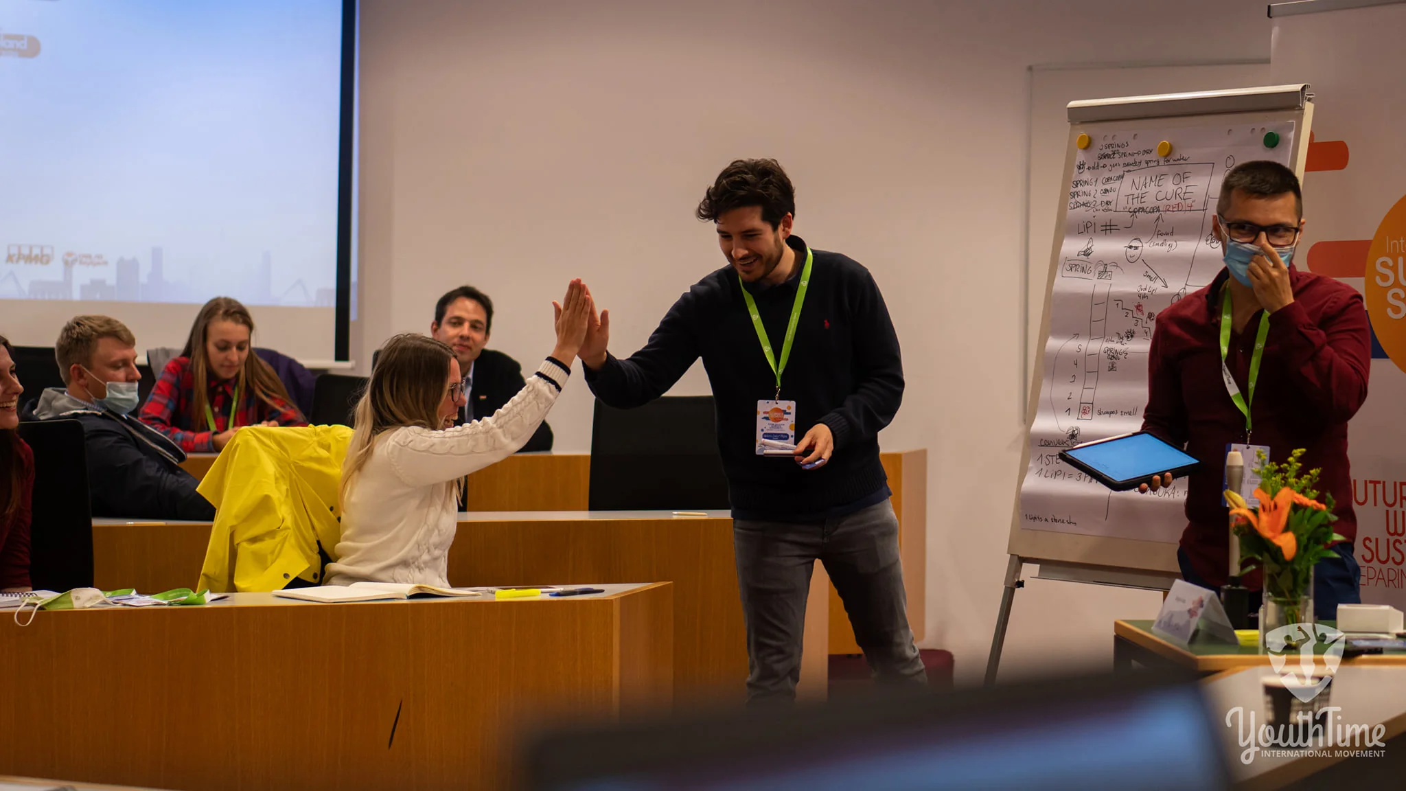 Nelson Inno chocando la mano con una participante en un taller de liderazgo juvenil